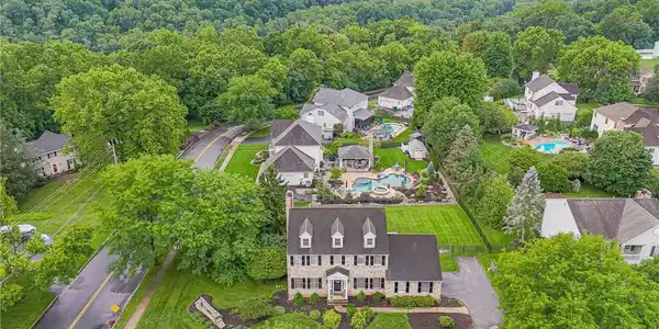 Image 4: An aerial perspective showcases a classic brick ho