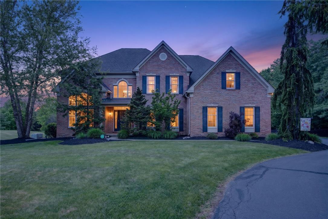 Image 2: A classic brick facade with contrasting shutters w