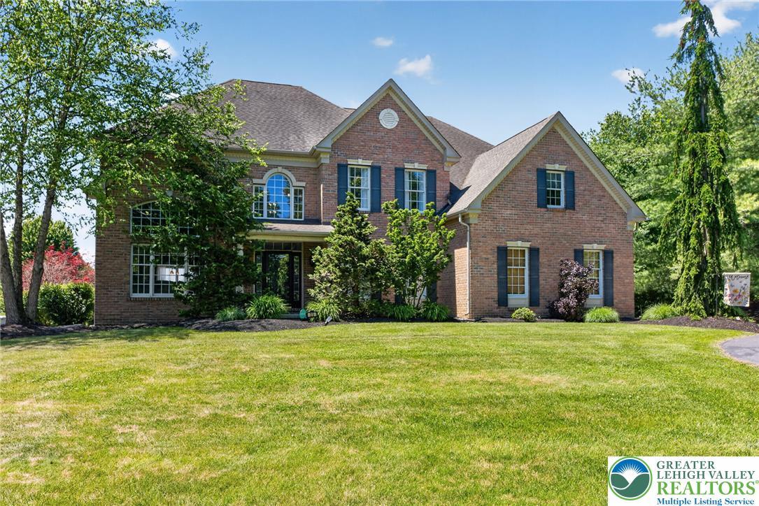 Image 3: A classic brick facade with well-maintained landsc