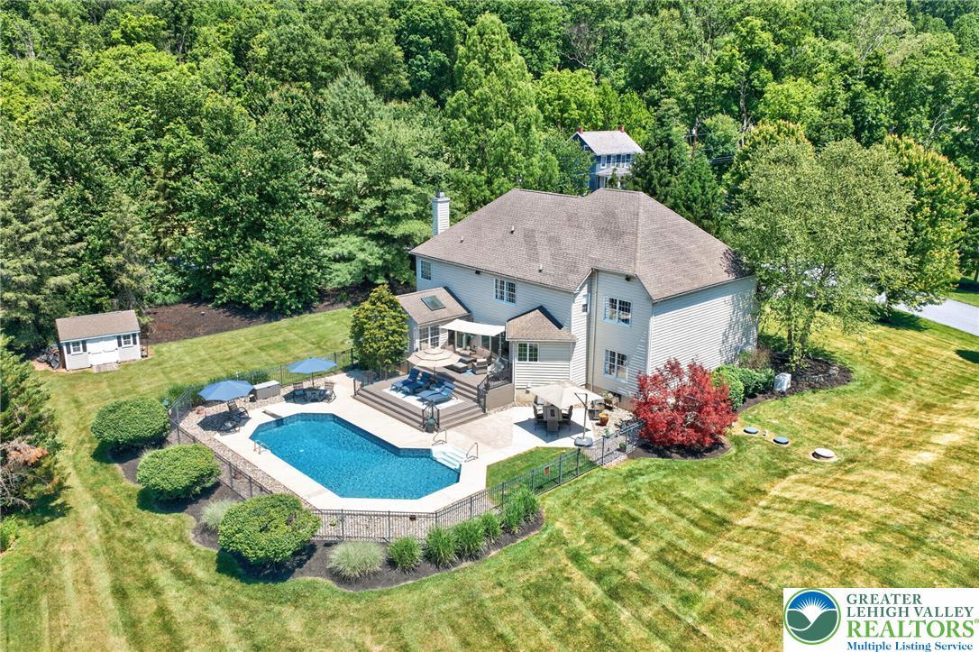 Image 4: An inviting pool and deck create an outdoor oasis
