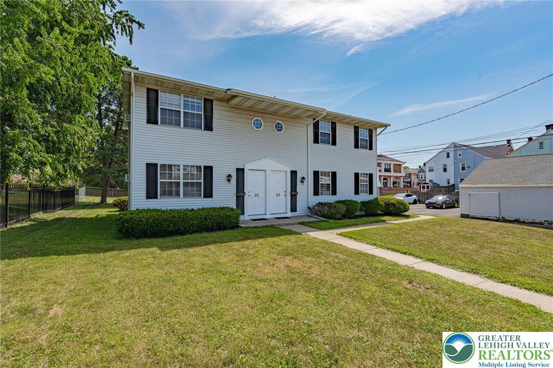 Image 2: Well-maintained siding and neatly trimmed shrubs e