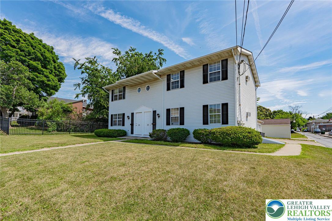 Image 3: A classic two-story duplex offers curb appeal with