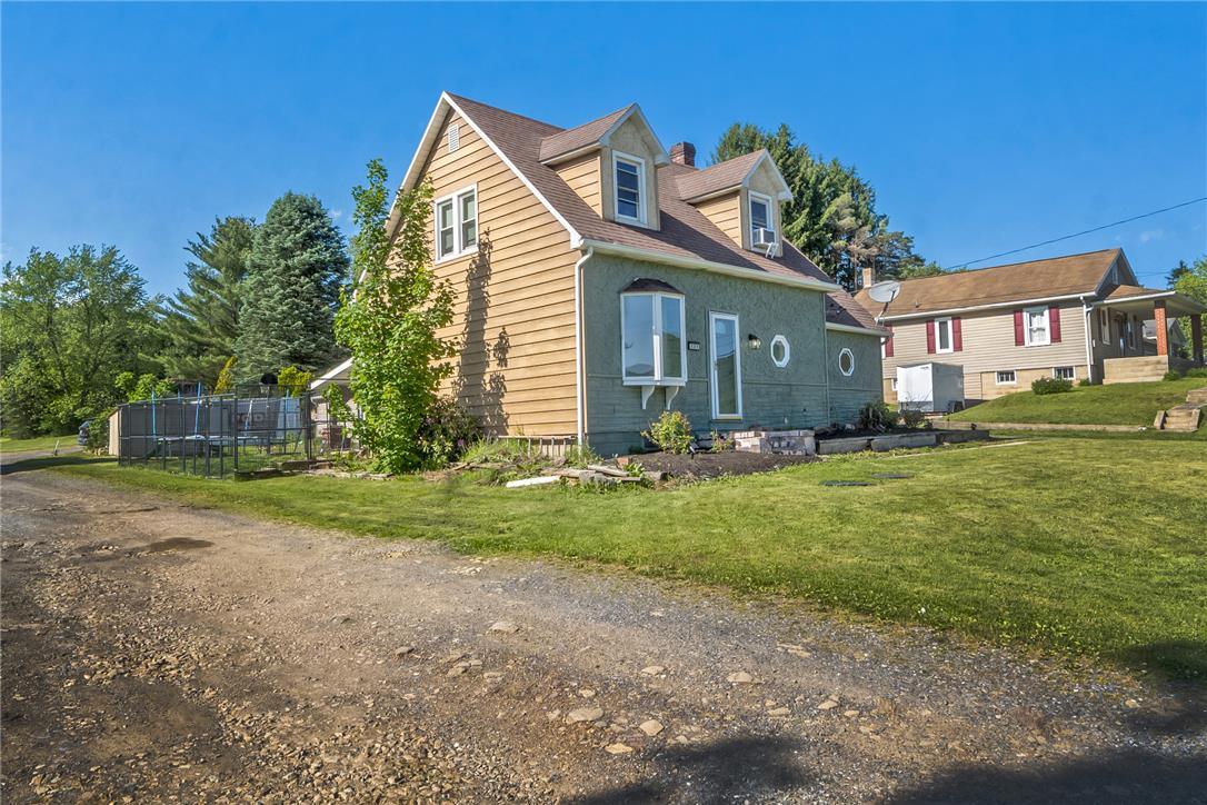 Image 3: A charming residence with a unique blend of siding
