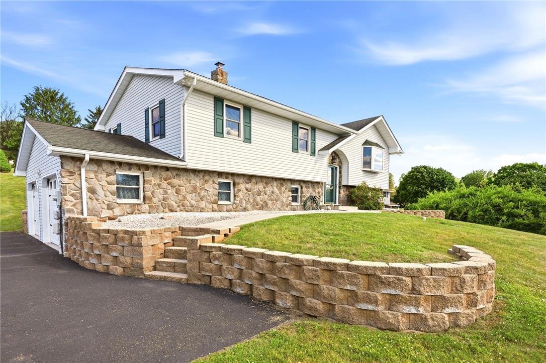 Image 4: Bi-level home with a stone and siding facade offer