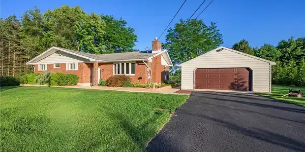 Image 2: A well-maintained brick ranch-style residence feat