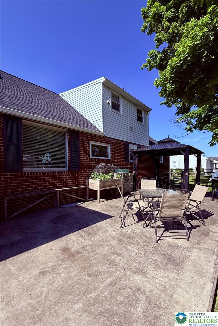 Image 4: Concrete patio offers an ideal space for outdoor e