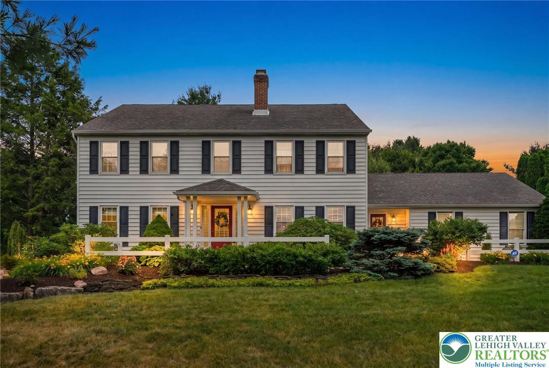 Image 2: A classic colonial home features a welcoming cover