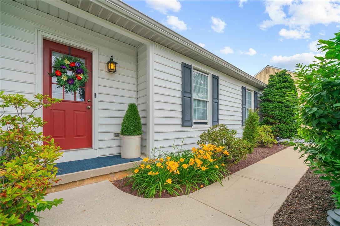 Image 4: A vibrant red entry door welcomes you to this char