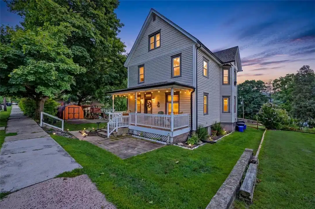 Image 1: A welcoming front porch enhances this classic mult