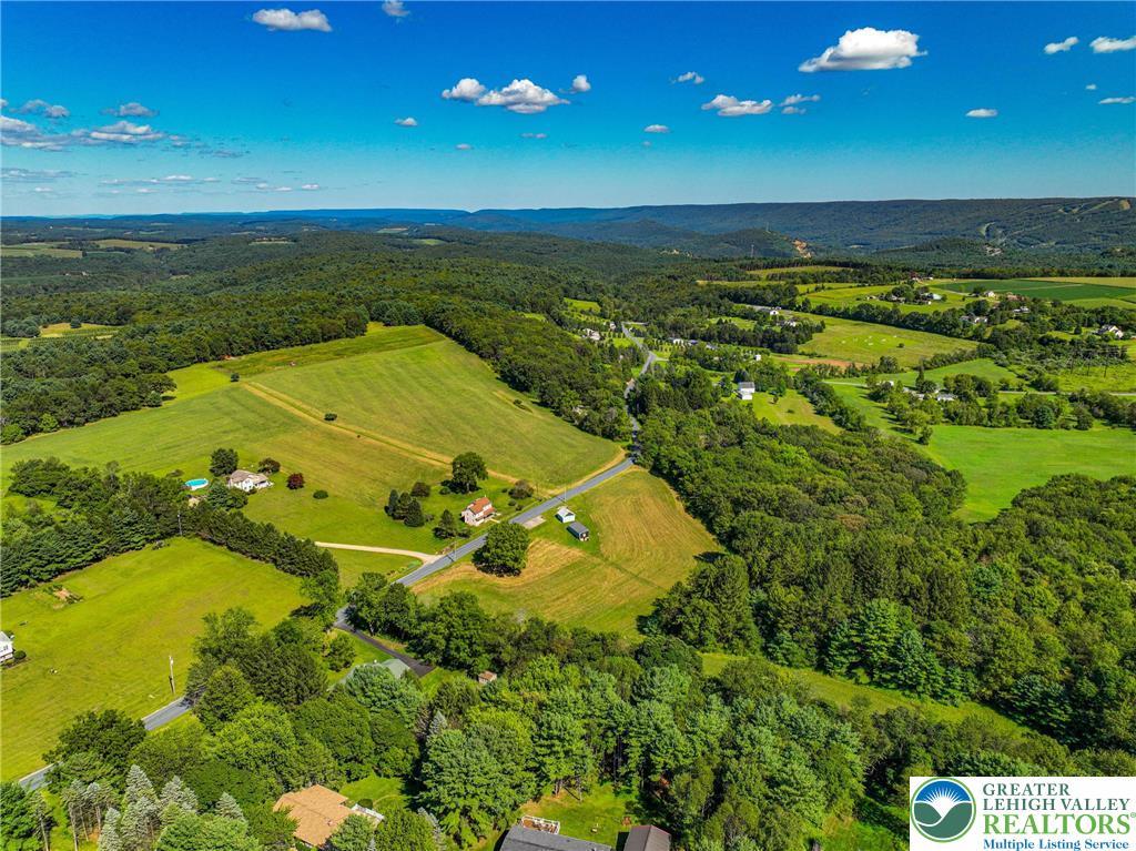 Image 3: Aerial view of home on land and vacant lot