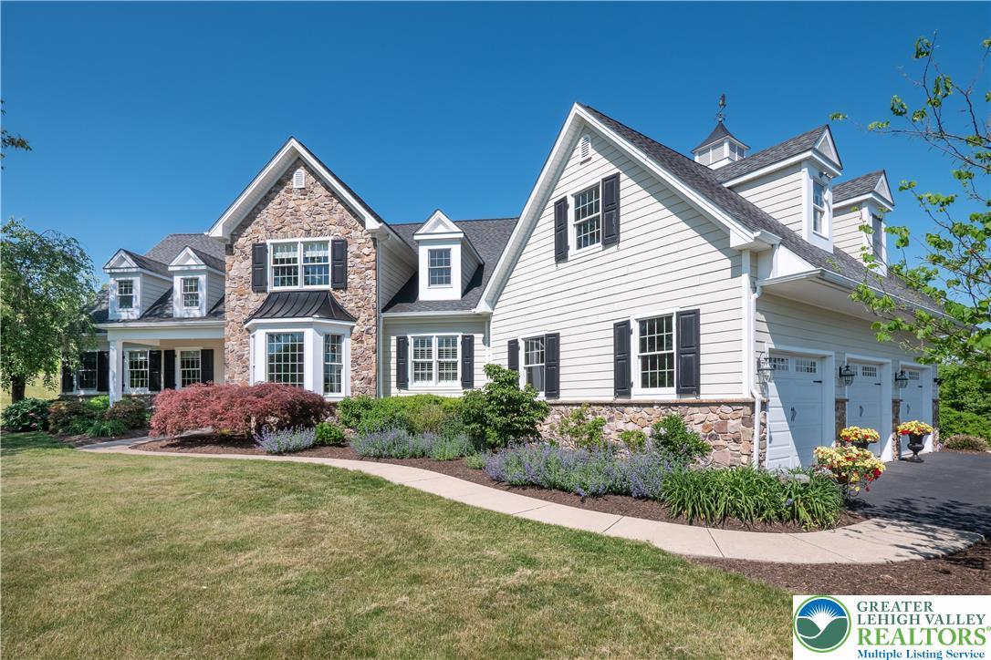 Image 2: A grand, stone and siding residence with ample lan