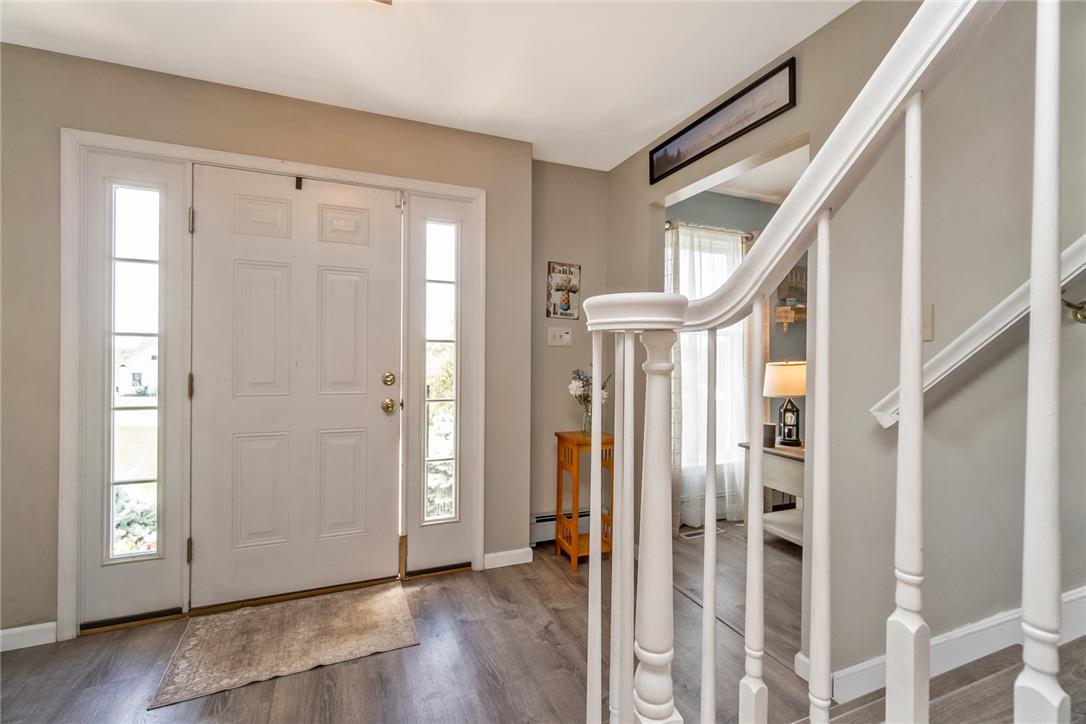 Image 4: A welcoming entry features a paneled front door fl