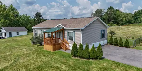 Image 2: A welcoming front porch leads to a tidy home, nest