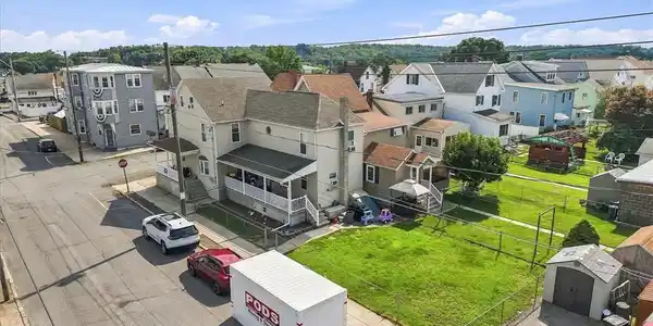 Image 3: An elevated perspective showcases home and its gre