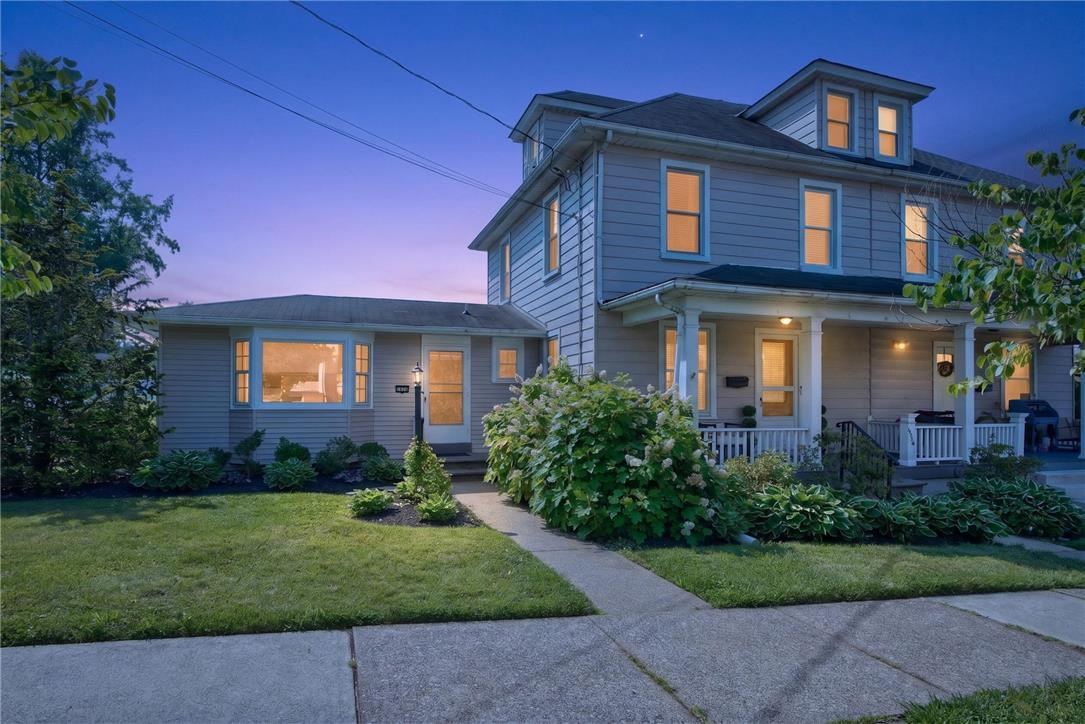 Image 2: A welcoming front porch invites you into this clas