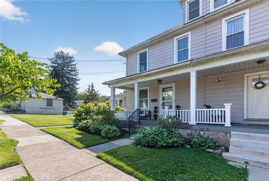 Image 4: A classic two-story residence with a welcoming fro