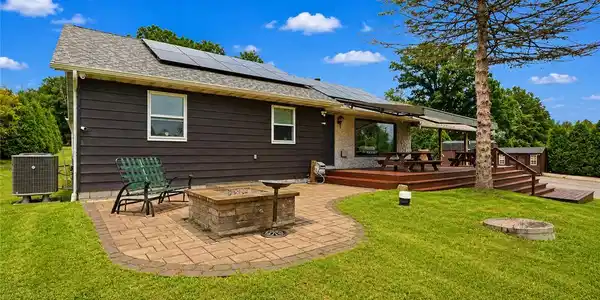 Image 4: An inviting stone patio and spacious wooden deck o