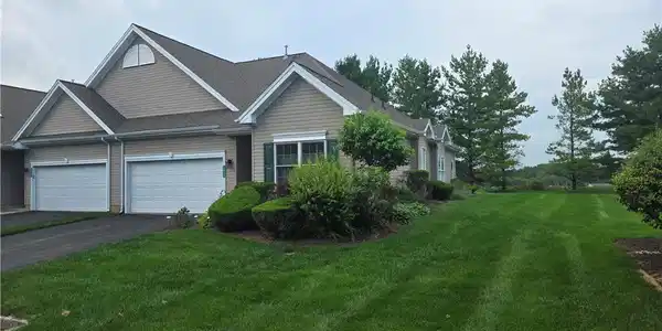 Image 3: Manicured lawns and mature trees frame this classi