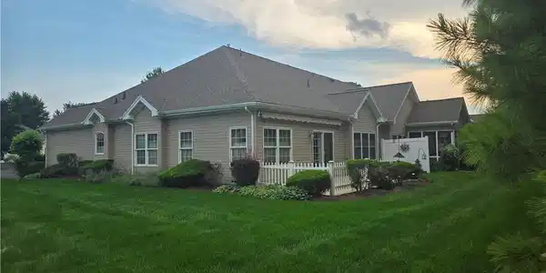 Image 4: Lush green grass surrounds this classic multi-gabl