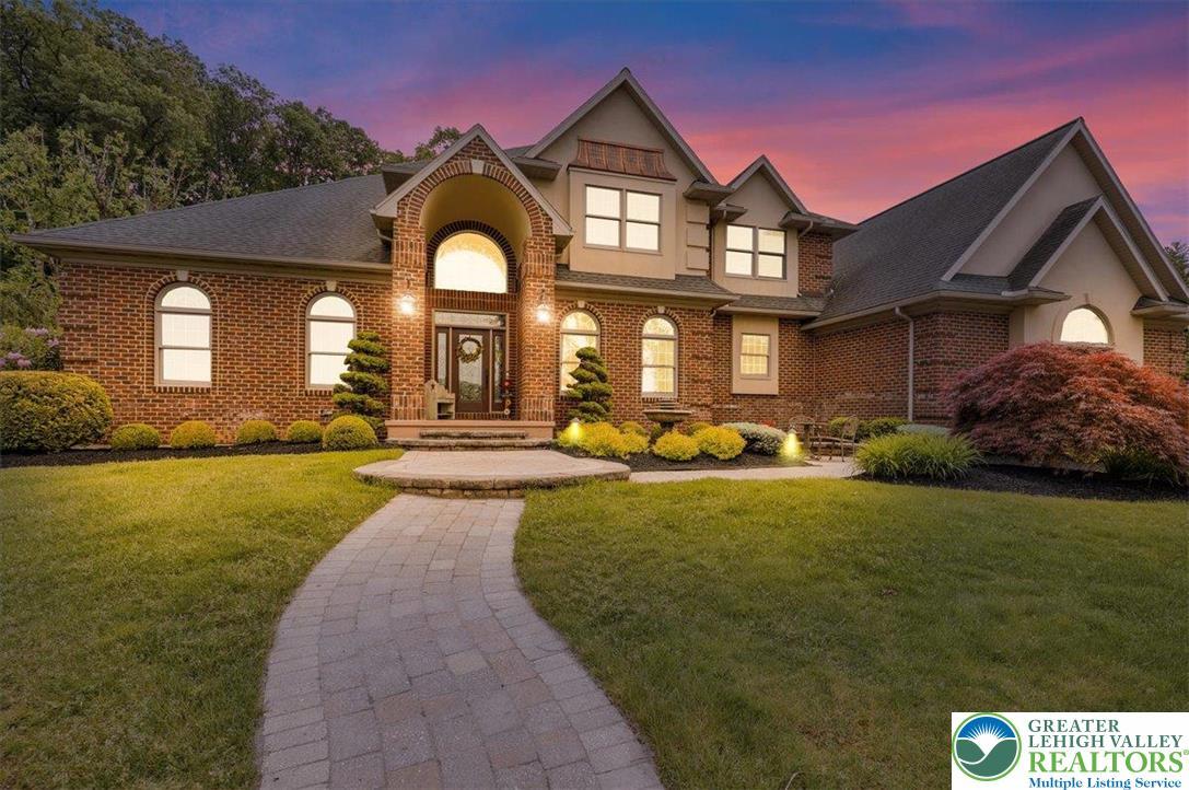 Image 1: A graceful brick residence with a charming arched