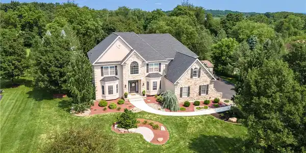 Image 2: A well-manicured lawn and established trees frame