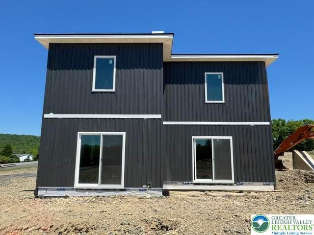 Image 2: Bold vertical siding and sleek window frames defin