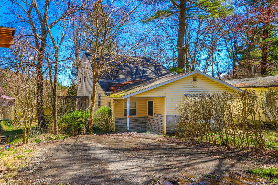 Image 2: A charming rustic dwelling featuring warm siding a