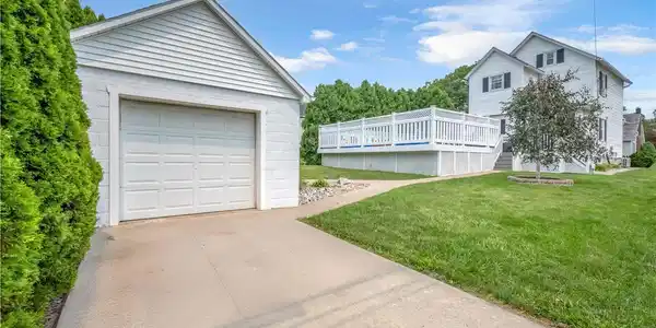 Image 2: A detached garage complements this property, featu