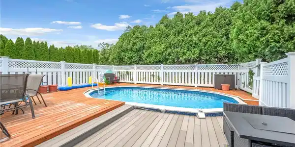 Image 3: A refreshing pool and spacious multi-level deck aw