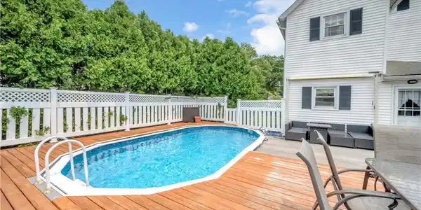 Image 4: A well-maintained pool and deck create an inviting