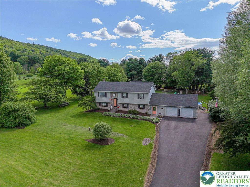 Image 3: Nestled into a green hillside, this property featu