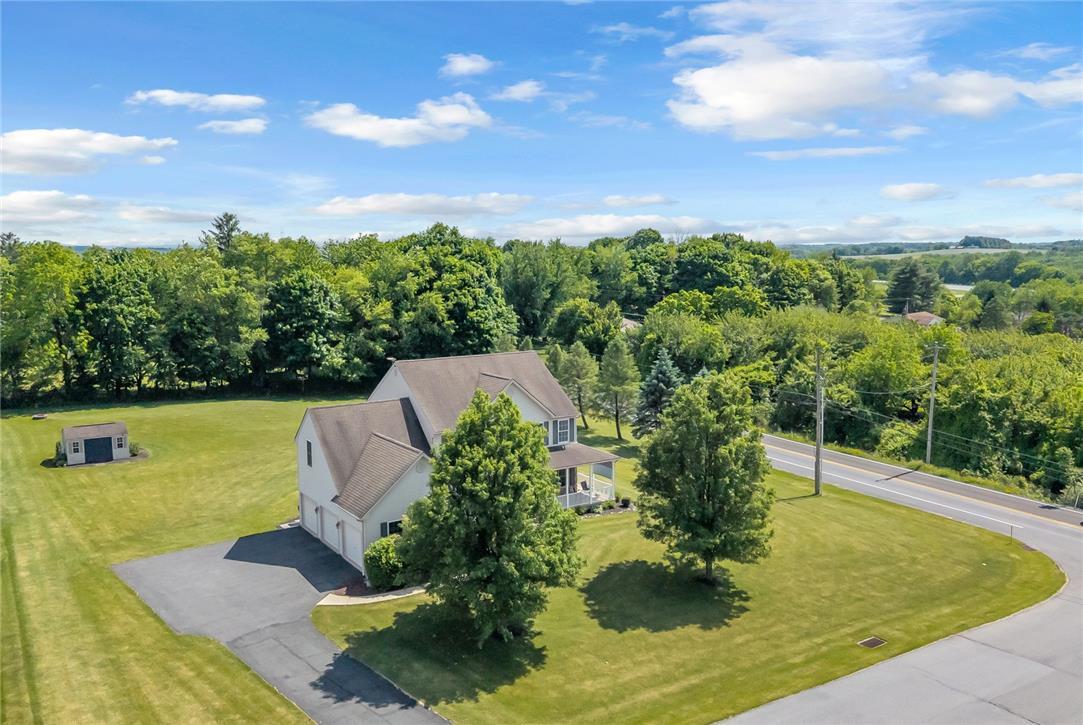 Image 2: Perched on a verdant lot, this charming residence