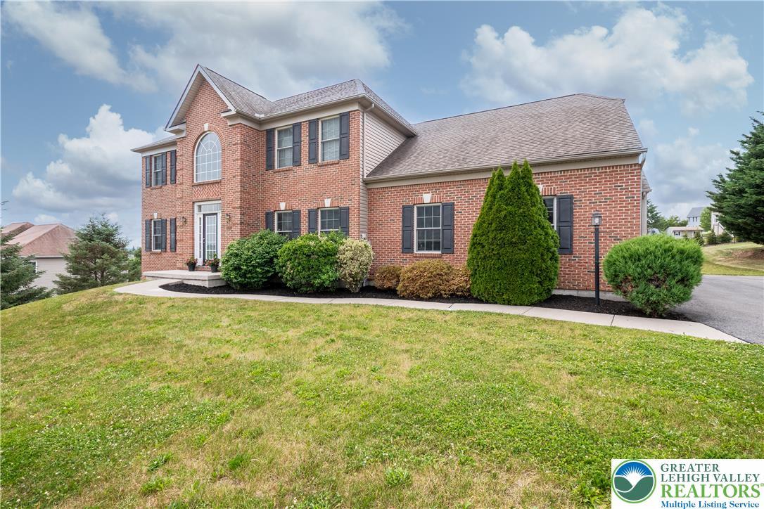 Image 3: A classic brick exterior, set on a verdant lawn, e