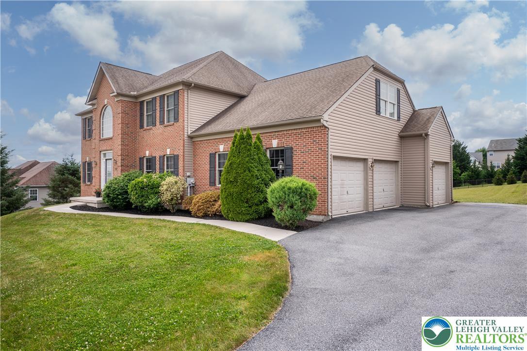 Image 4: A classic brick and siding home features a multi-c