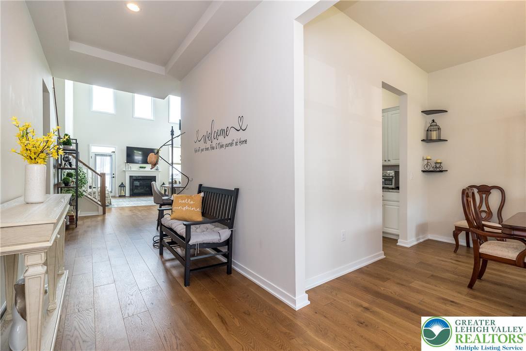 Image 3: Warm wood flooring  offering glimpses of an inviti