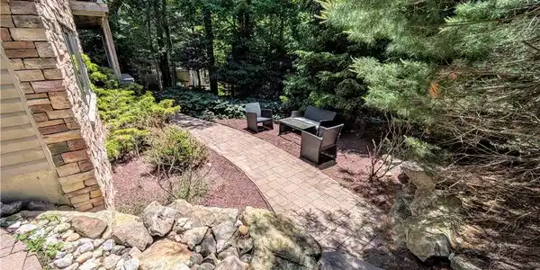 Image 4: A winding brick pathway leads to a secluded outdoo