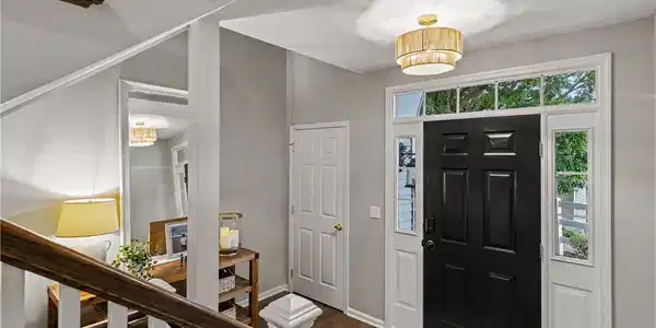 Image 2: A welcoming entryway with rich hardwood floors, si