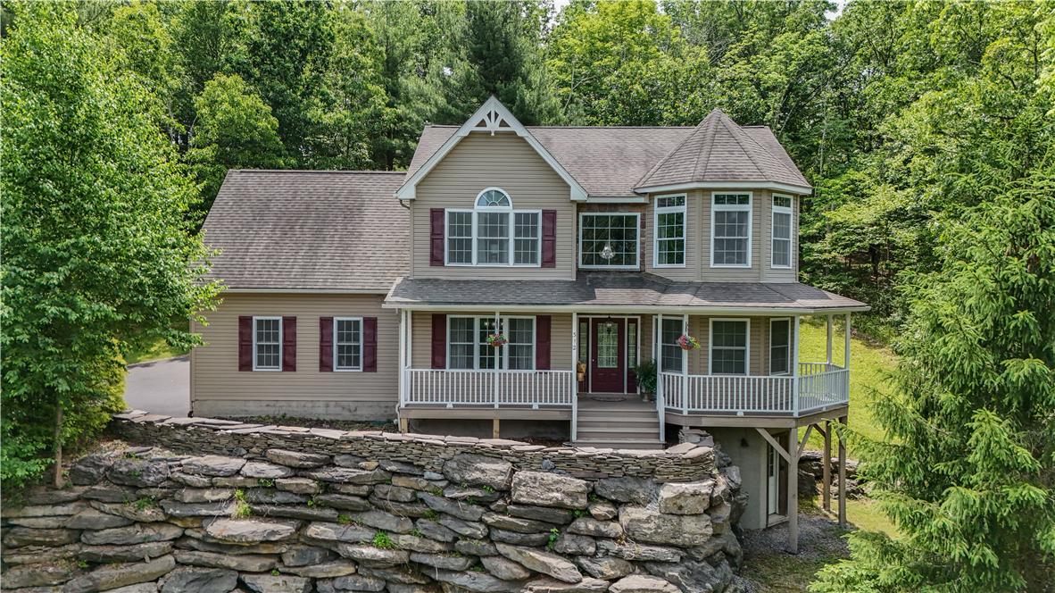 Image 2: A charming home nestled amongst green trees with a