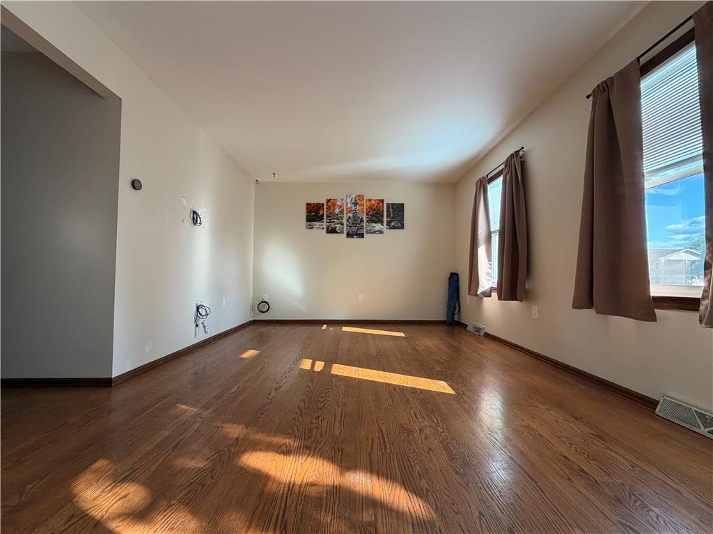 Image 2: Rich hardwood floors flow through this sun-drenche