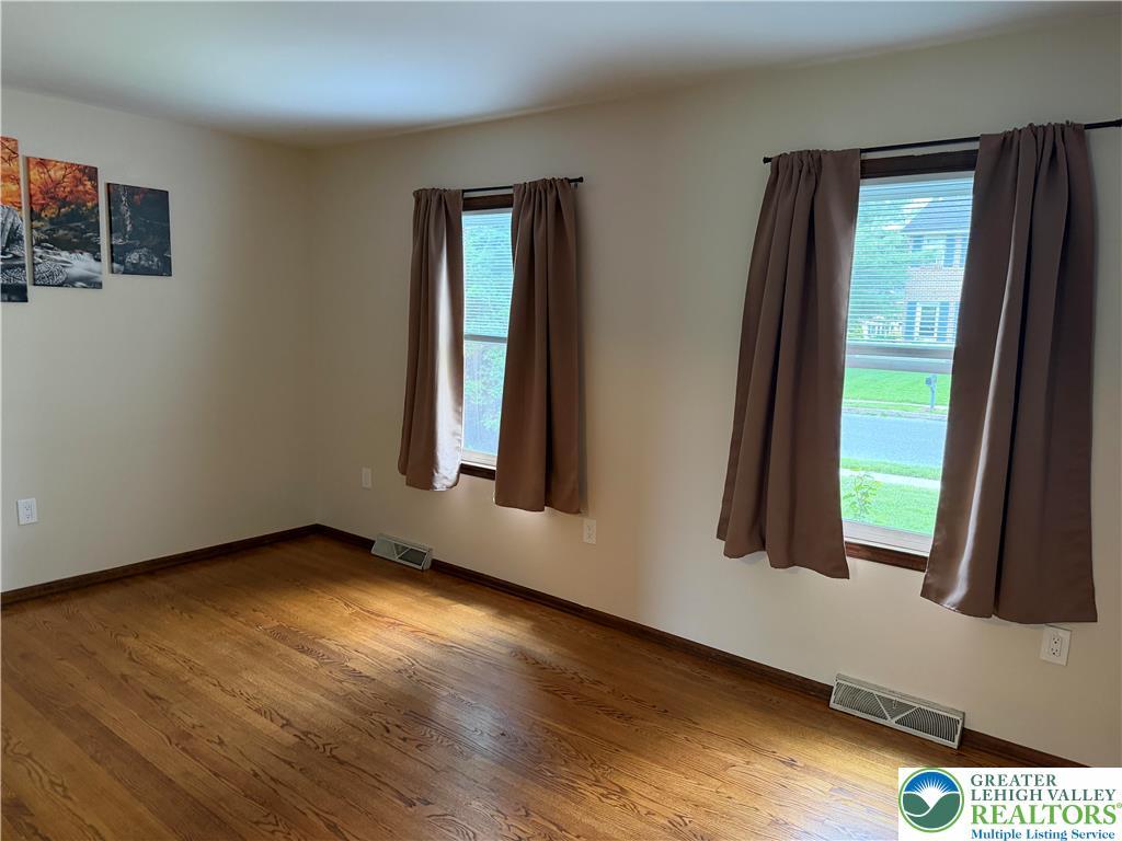 Image 3: Hardwood flooring extends throughout this well-lit