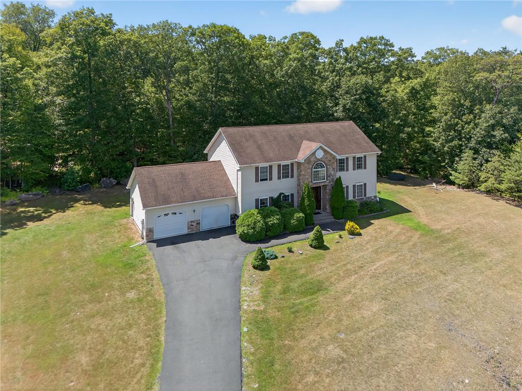 Image 3: Perched on a verdant lot, this residence offers a