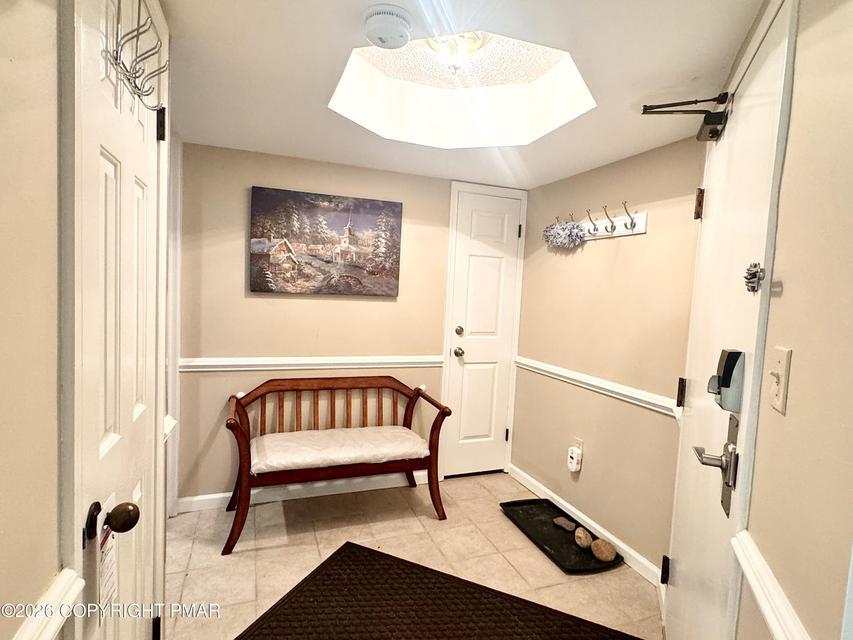 Image 3: A welcoming entryway with practical tile flooring.