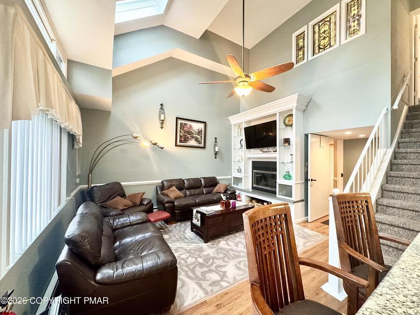 Image 4: Natural light floods this living area, showcasing