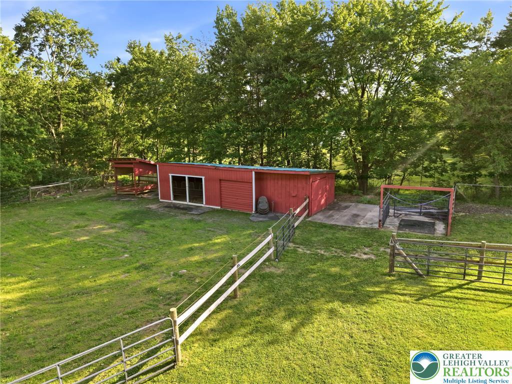 Image 4: A pastoral expanse offers a red barn, ample yard s