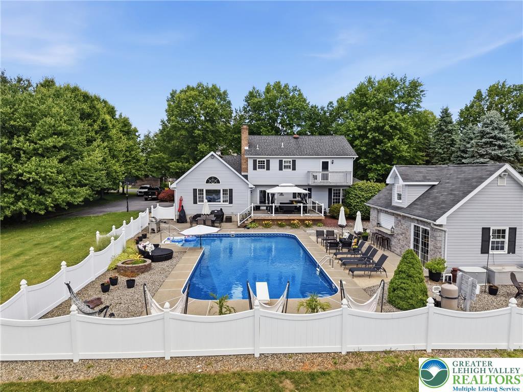Image 2: An inviting backyard oasis offers a sparkling in-g