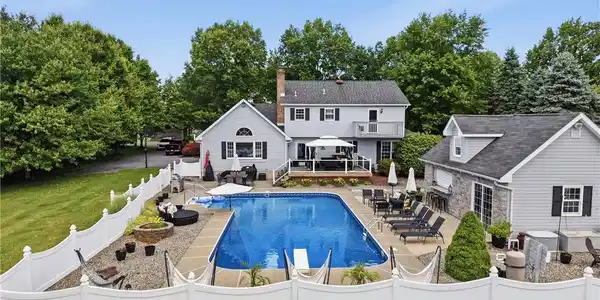 Image 2: An inviting backyard oasis offers a sparkling in-g