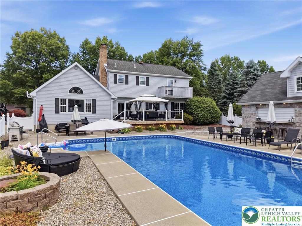 Image 3: An inviting backyard oasis awaits with a sparkling