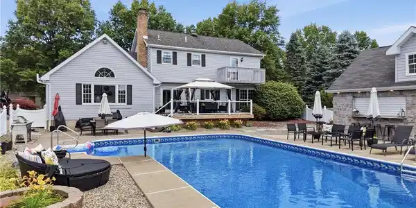 Image 3: An inviting backyard oasis awaits with a sparkling