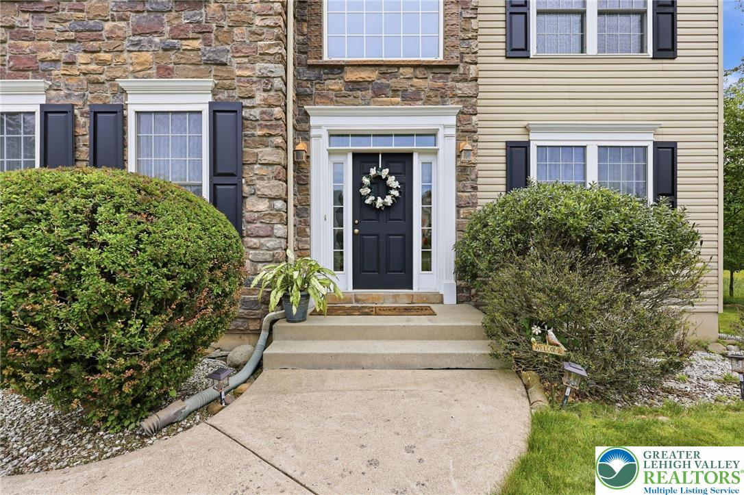 Image 3: A classic facade combining stone and siding with n