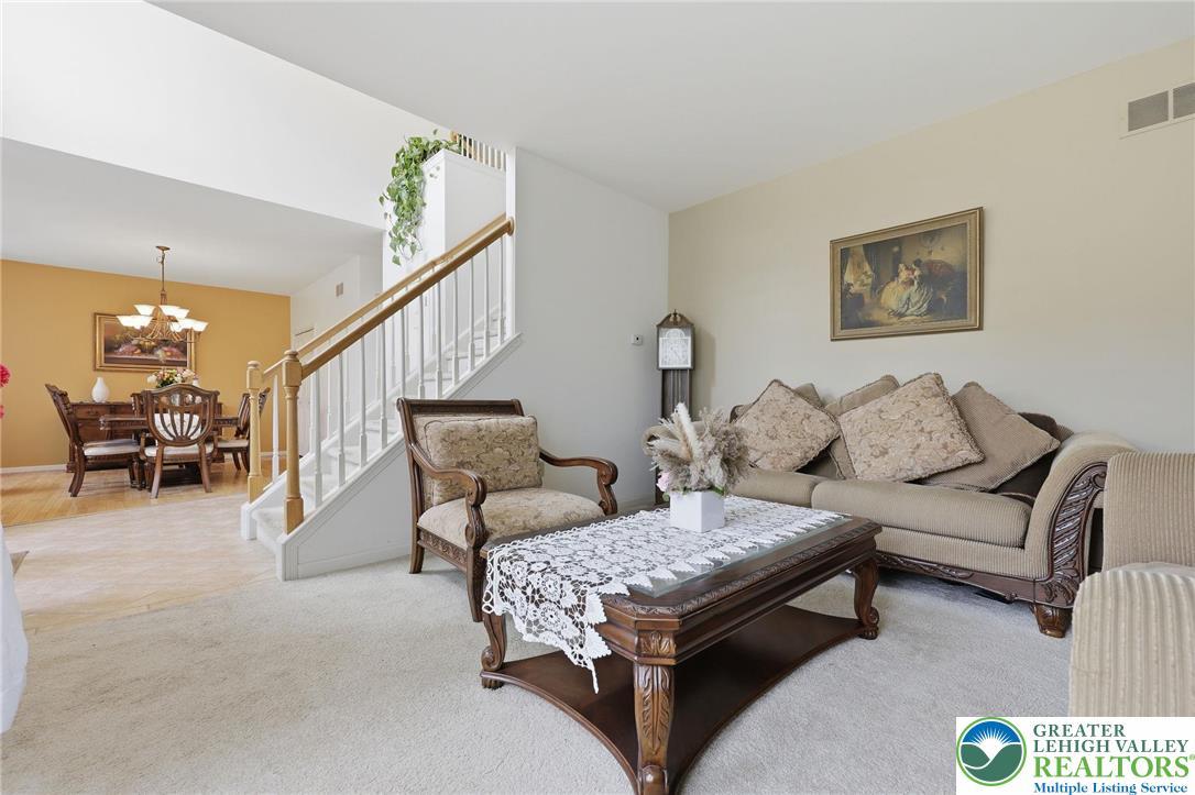 Image 4: An inviting living room seamlessly flows into the
